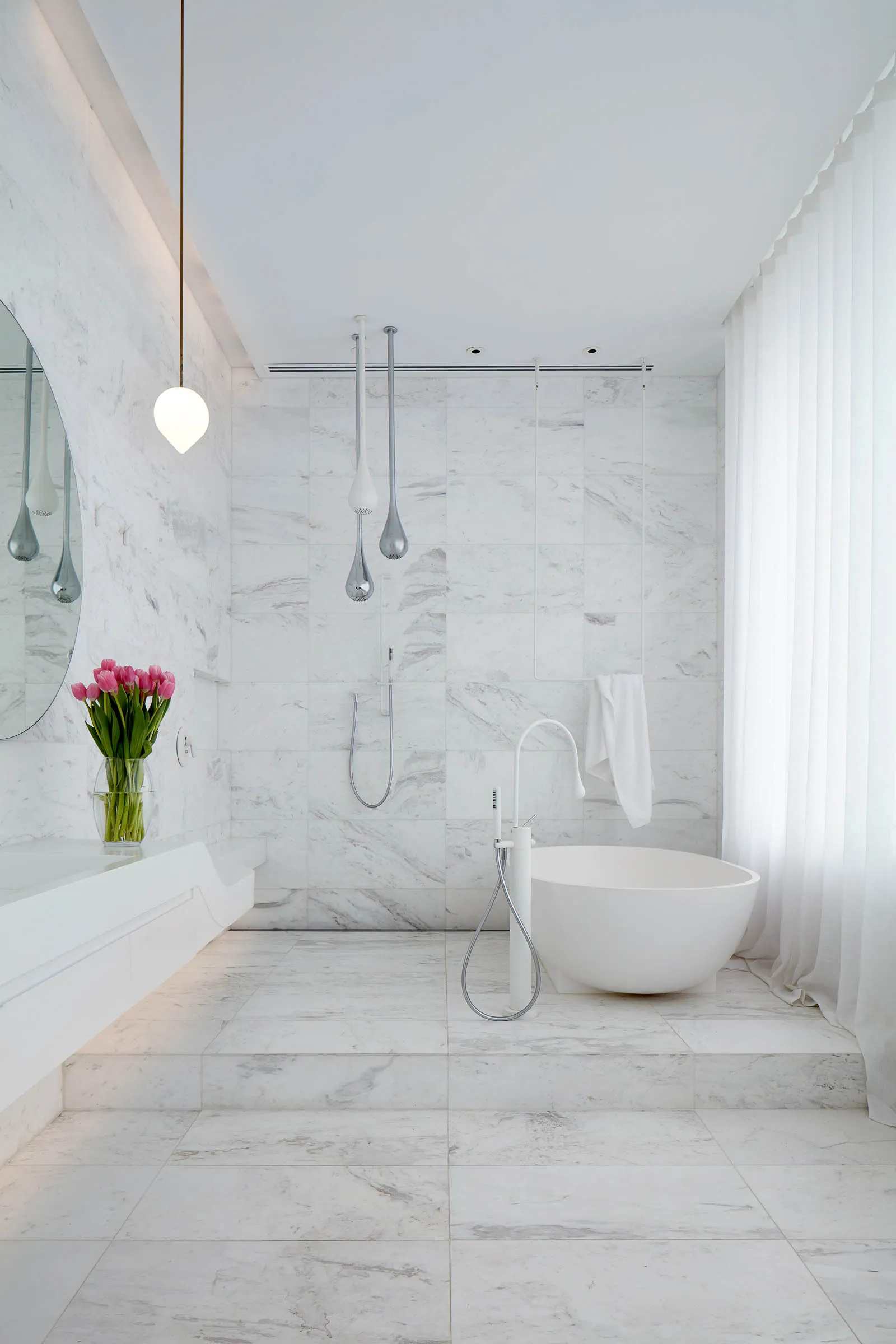 A luxurious modern bathroom featuring white marble walls and floor tiles, a freestanding bathtub, and a minimalist design.