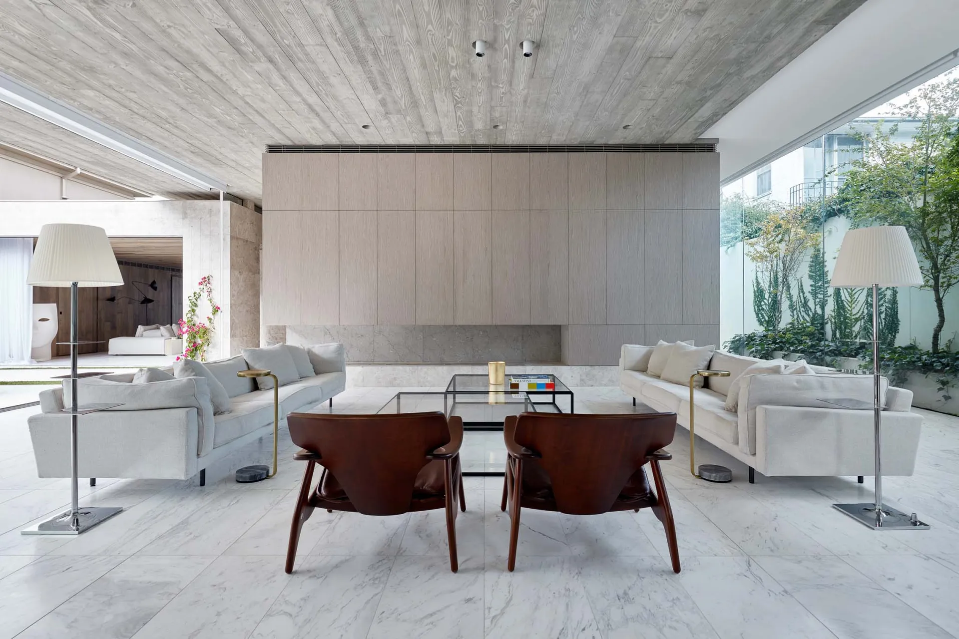 A modern living room with marble flooring, minimalist furniture, and clean lines.