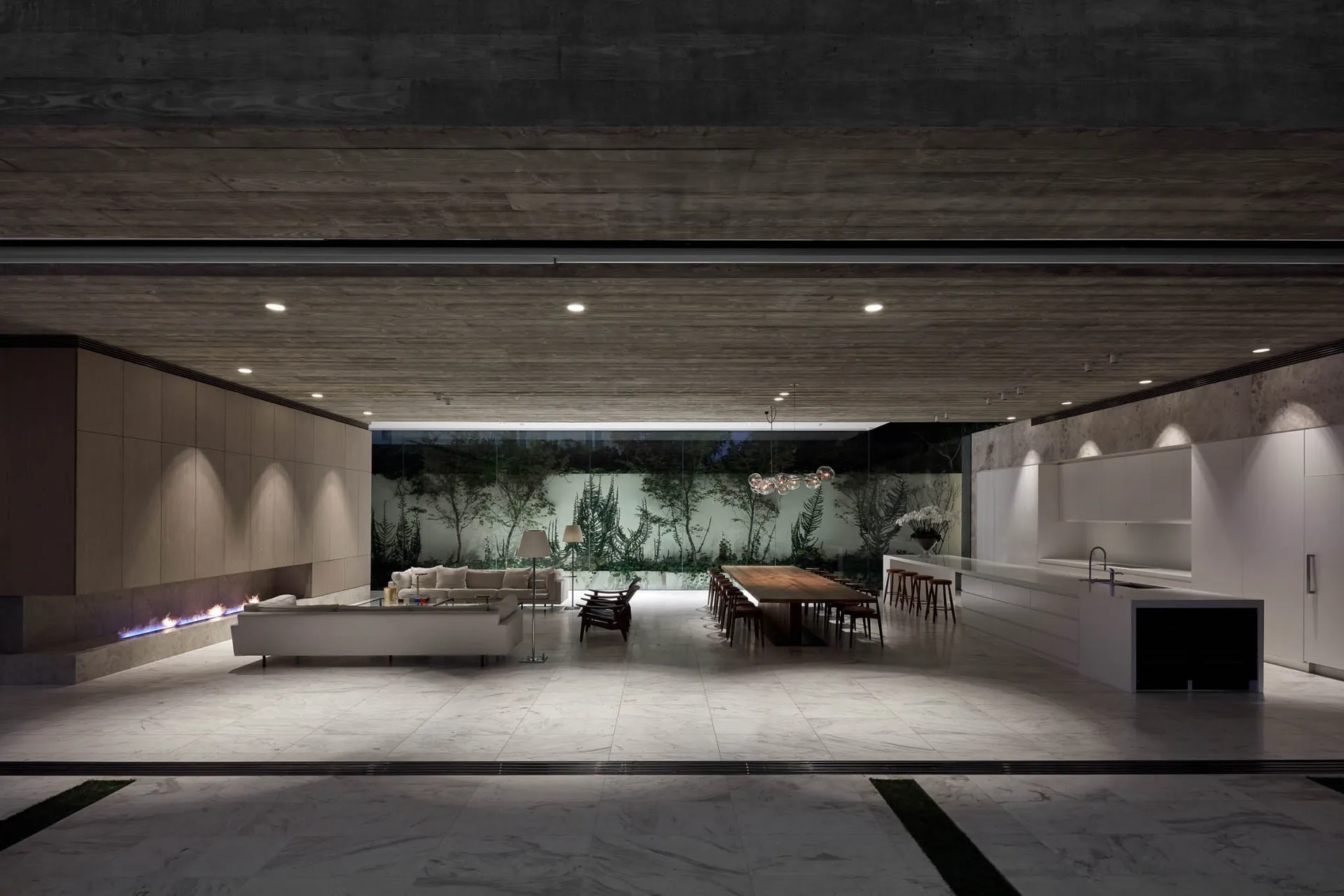 A modern living room featuring a marble floor and concrete walls.