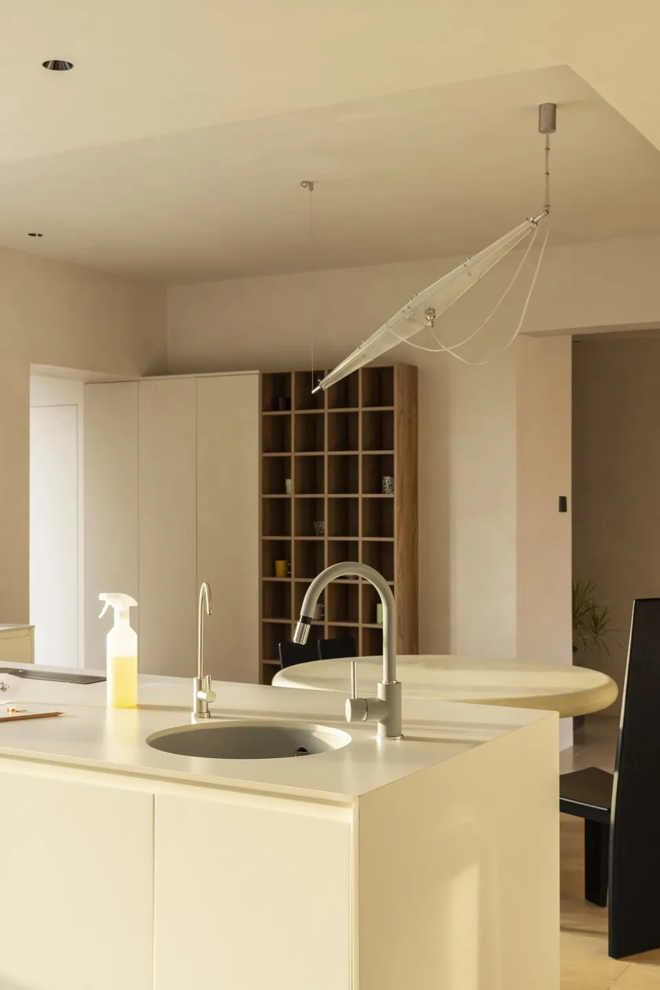 A modern minimalist kitchen with sleek lines and a sleek faucet.