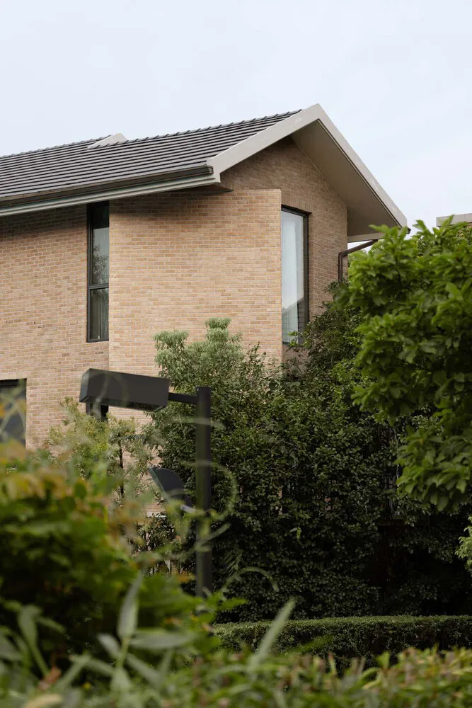 Modern residential house with brick exterior and a gable roof.