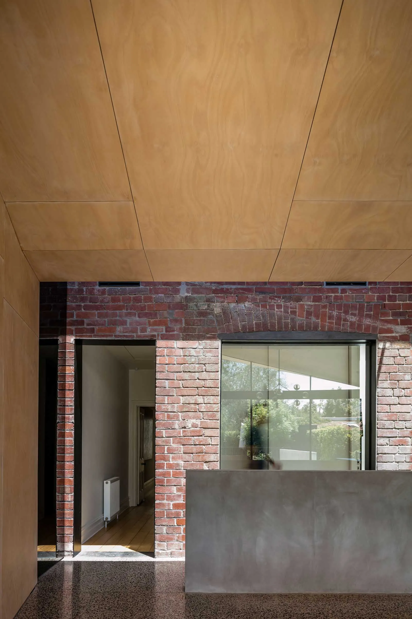 Modern interior with brick wall and wooden ceiling.