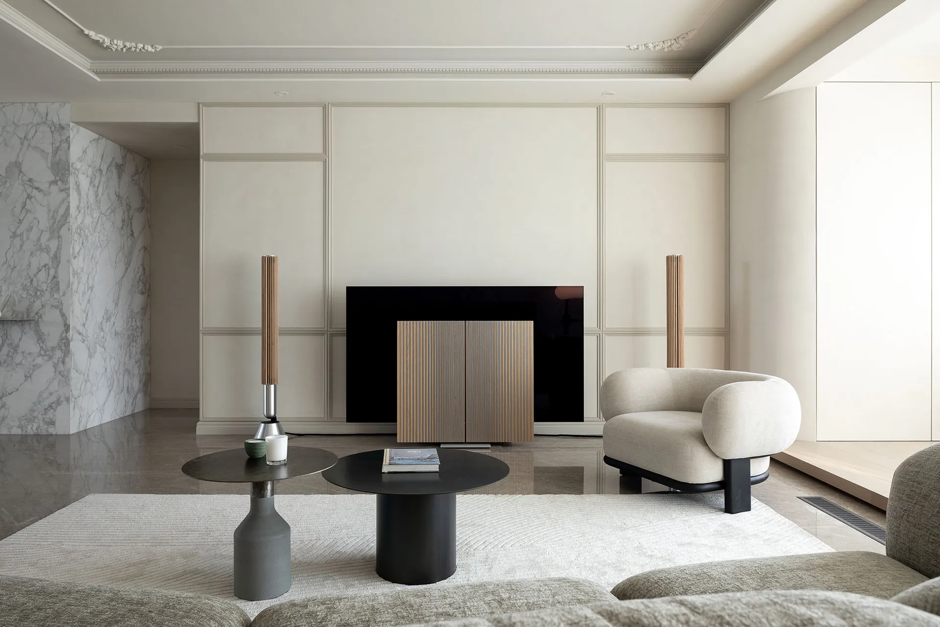 Modern, minimalist living room featuring marble accents, wood furniture, and leather seating.