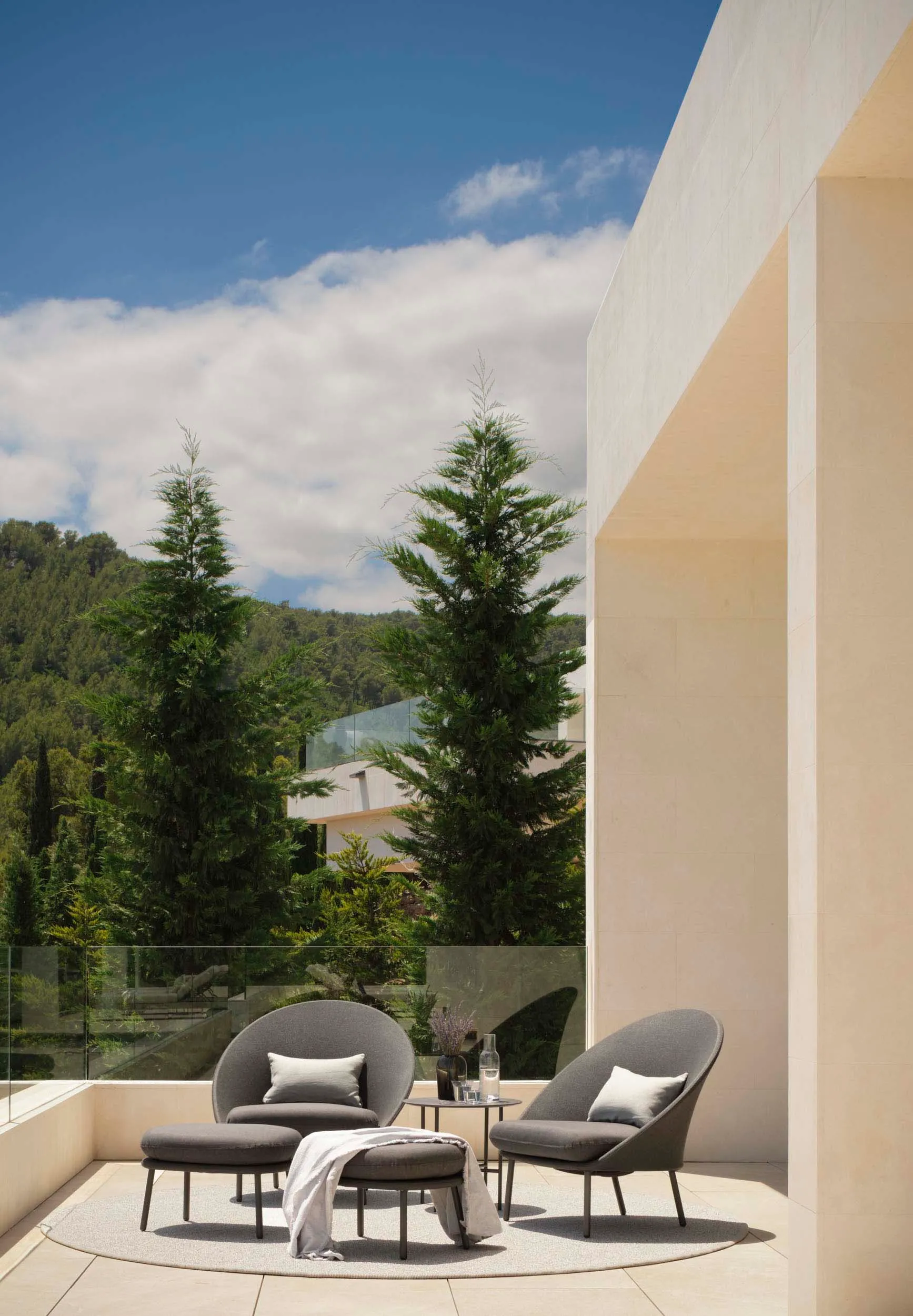Outdoor seating area with concrete furniture and minimalist design on a balcony