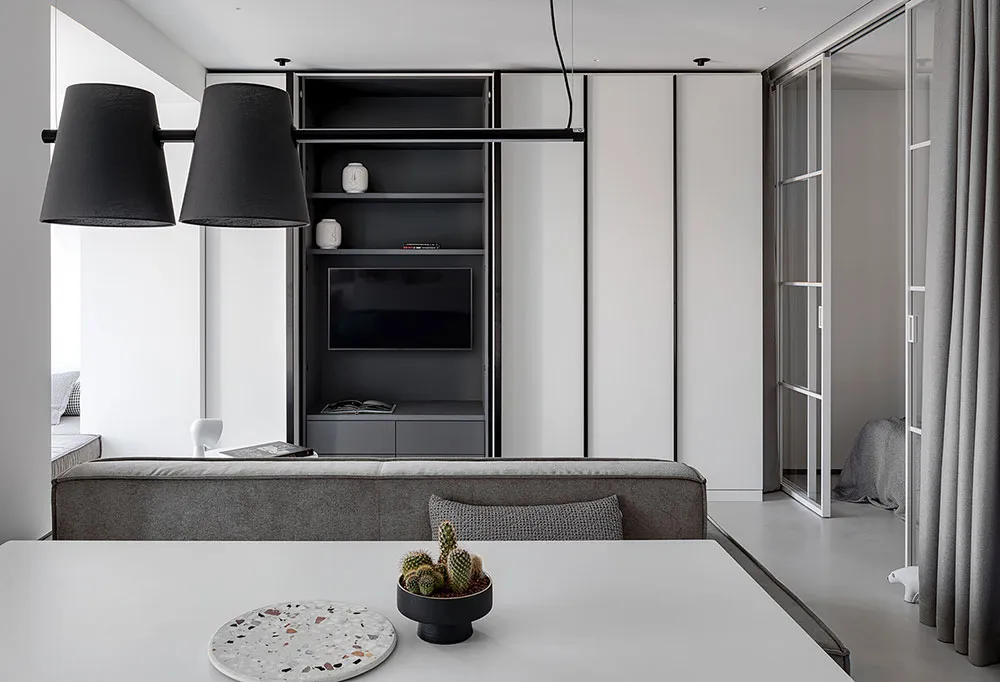 Modern living room with concrete furniture and minimalist design.