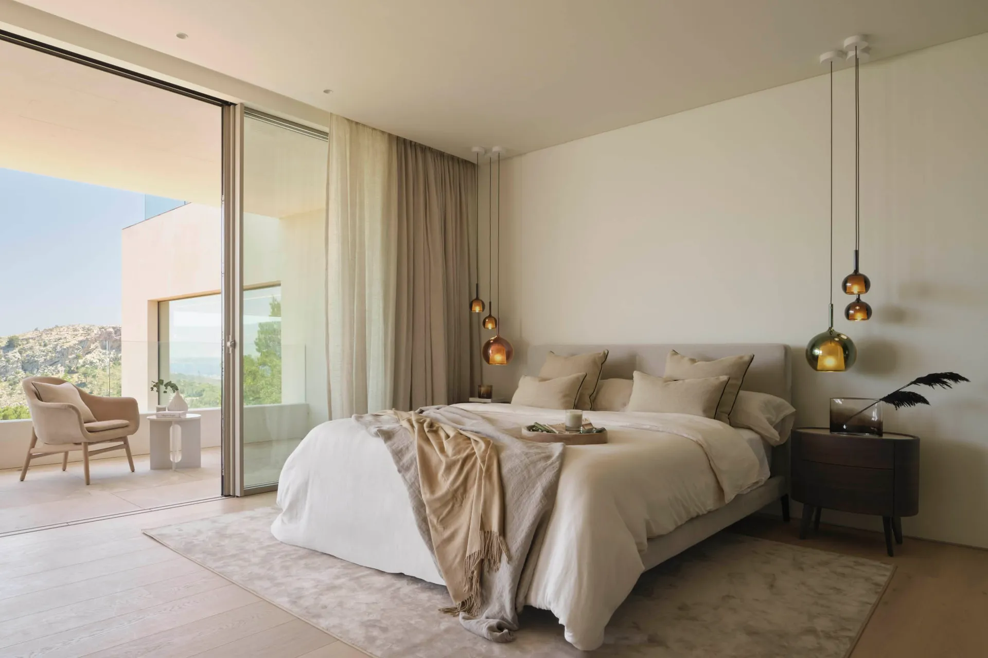 Minimalist bedroom featuring a glass wall, fabric bedding, and wooden floor.