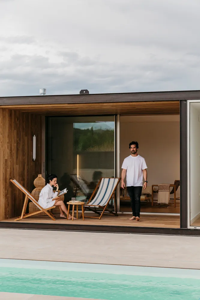 A modern terrace with wooden construction and a pool.