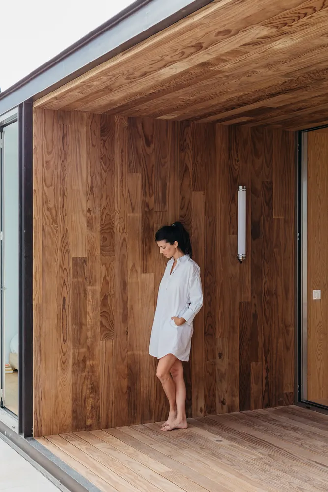 A minimalist interior space with wooden walls and a wooden floor.