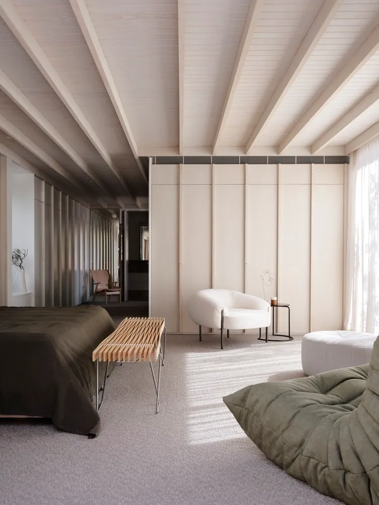 Minimalist bedroom featuring a wooden floor and minimalist furniture.