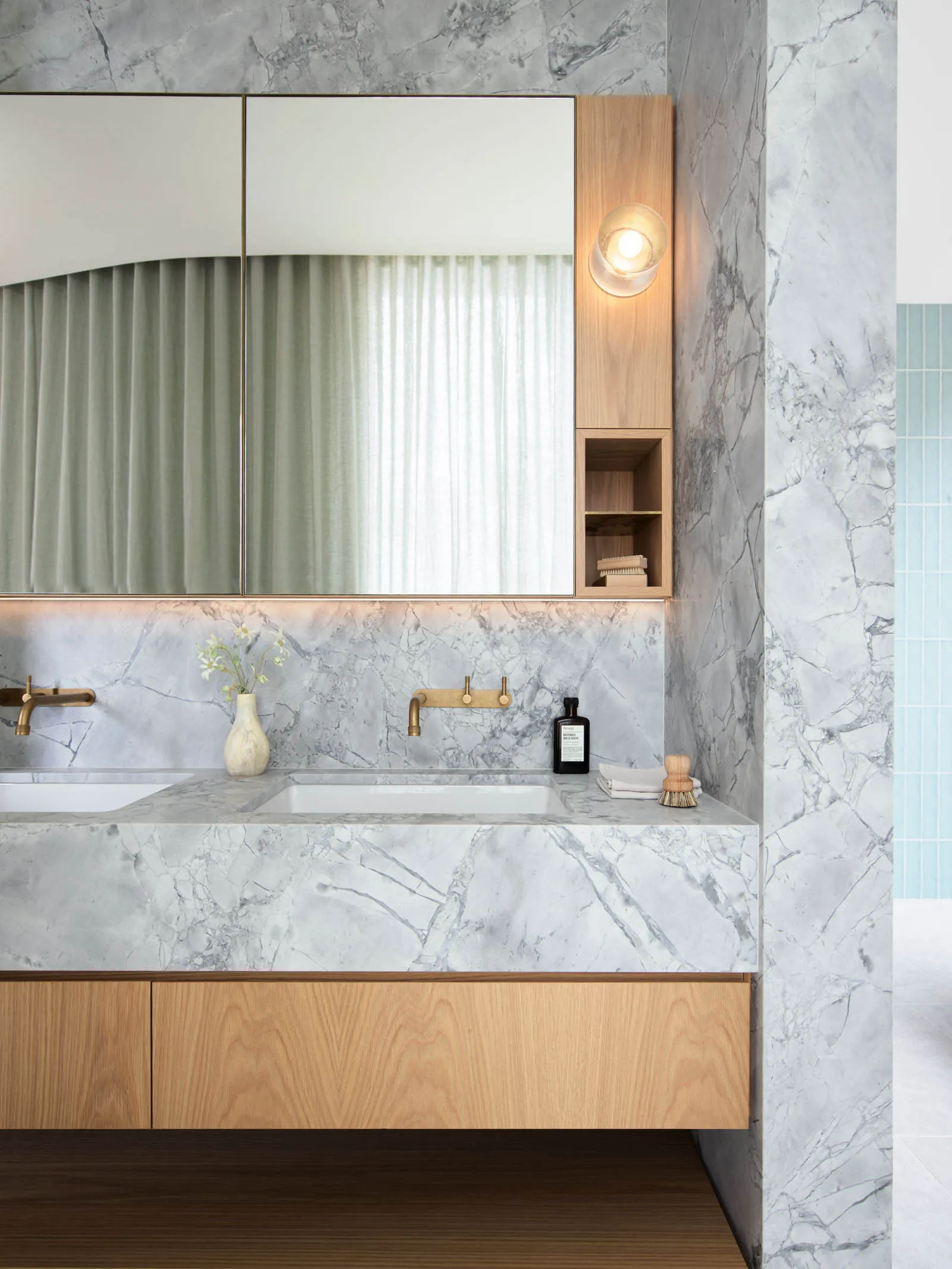 Modern bathroom featuring a marble countertop and wooden cabinets