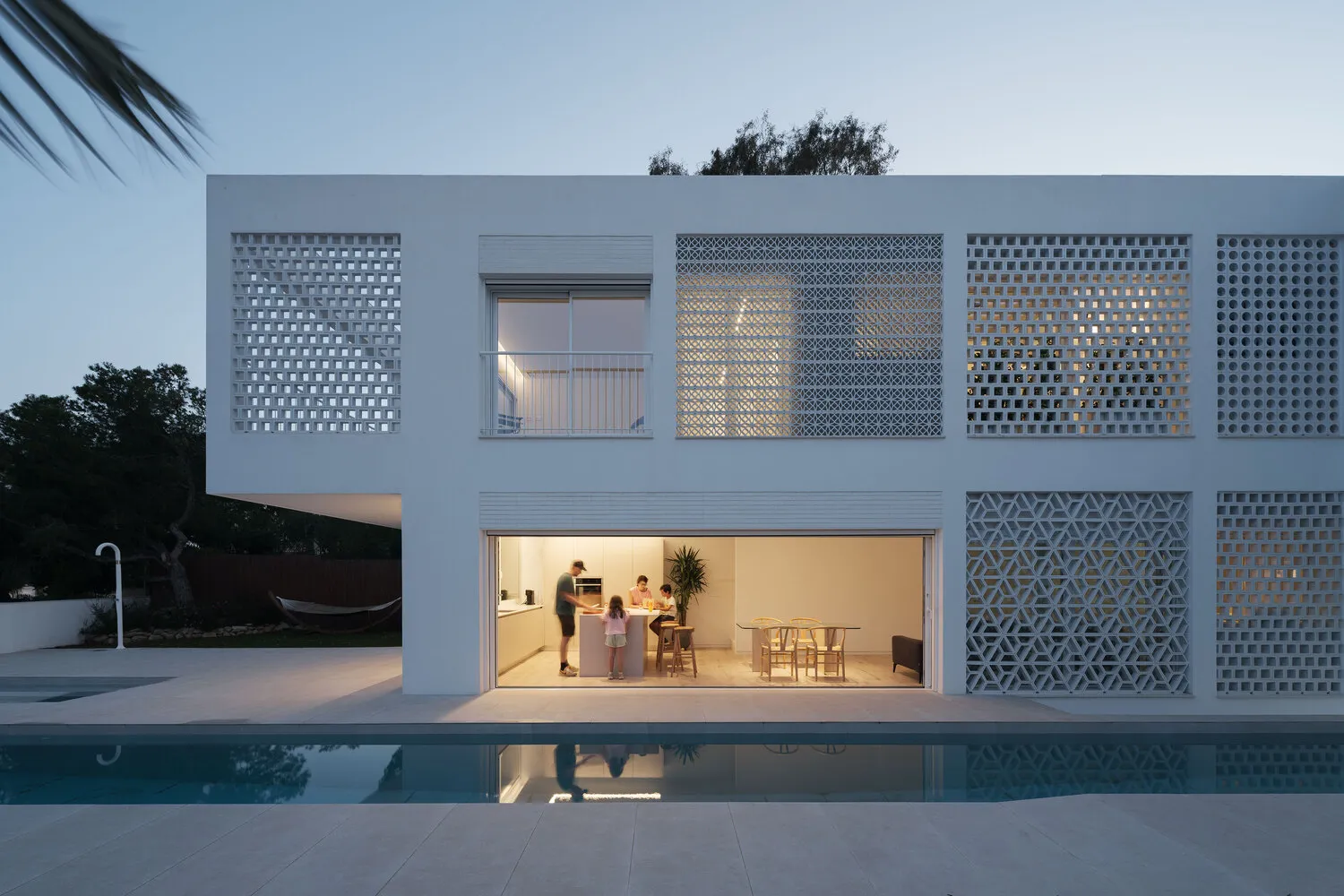 An image of a modern residential home featuring lattice panels on the exterior.