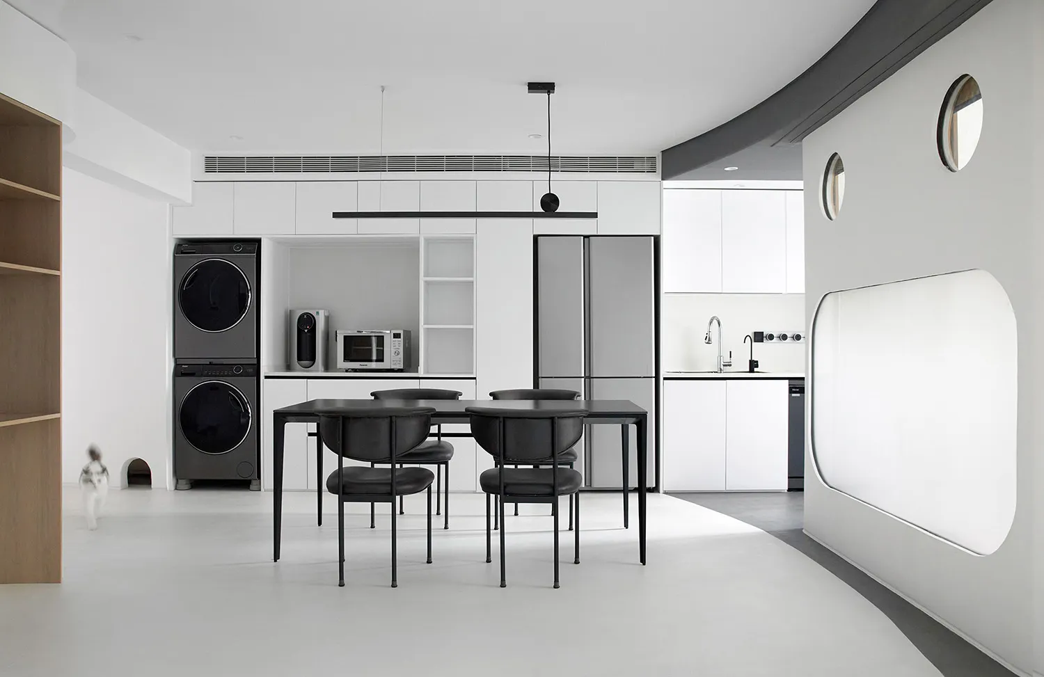 A modern, minimalist, all-white interior design featuring sleek furniture, clean lines, and a neutral color palette.
