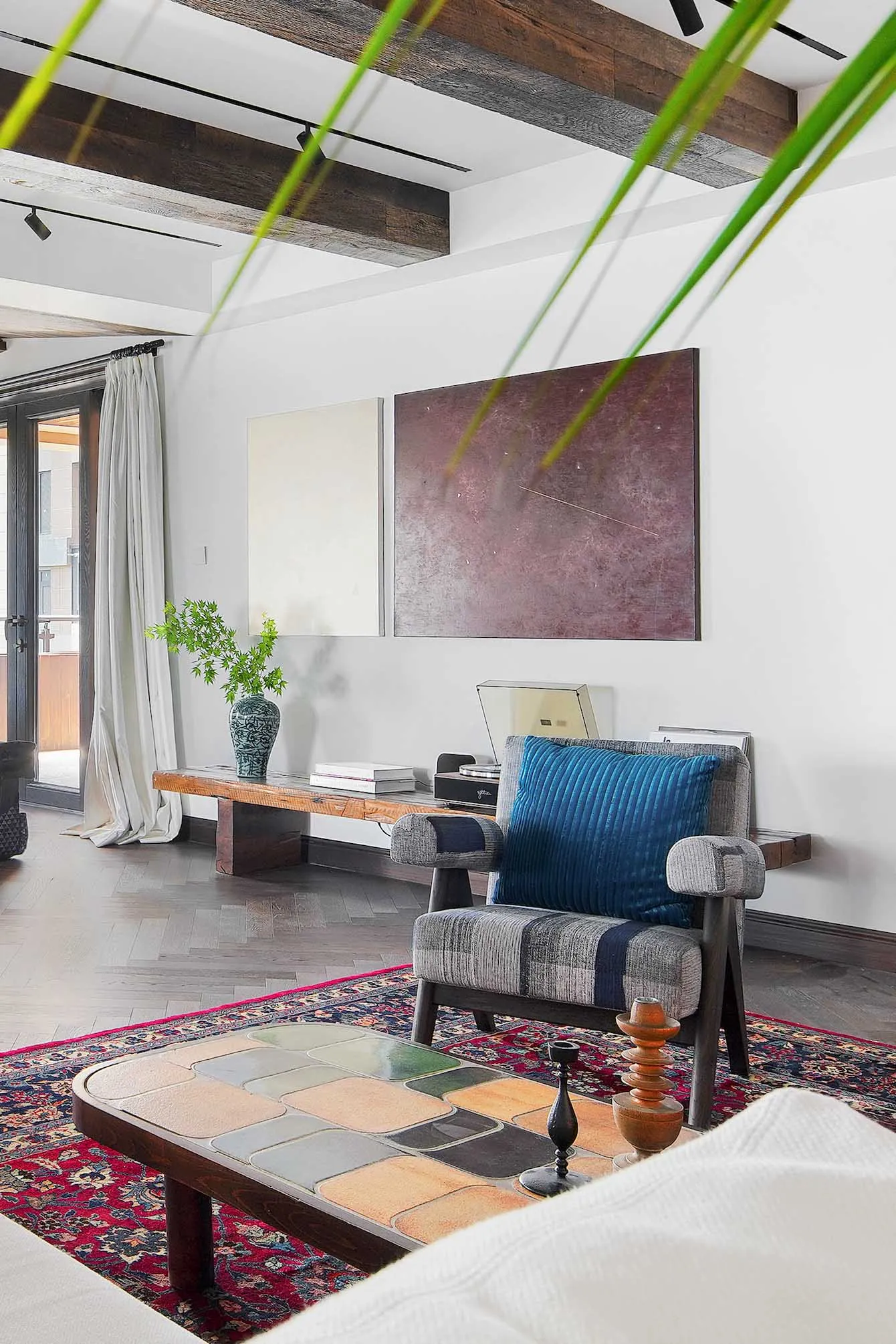 A living room featuring industrial design elements such as wood, ceramic tiles, and fabric.