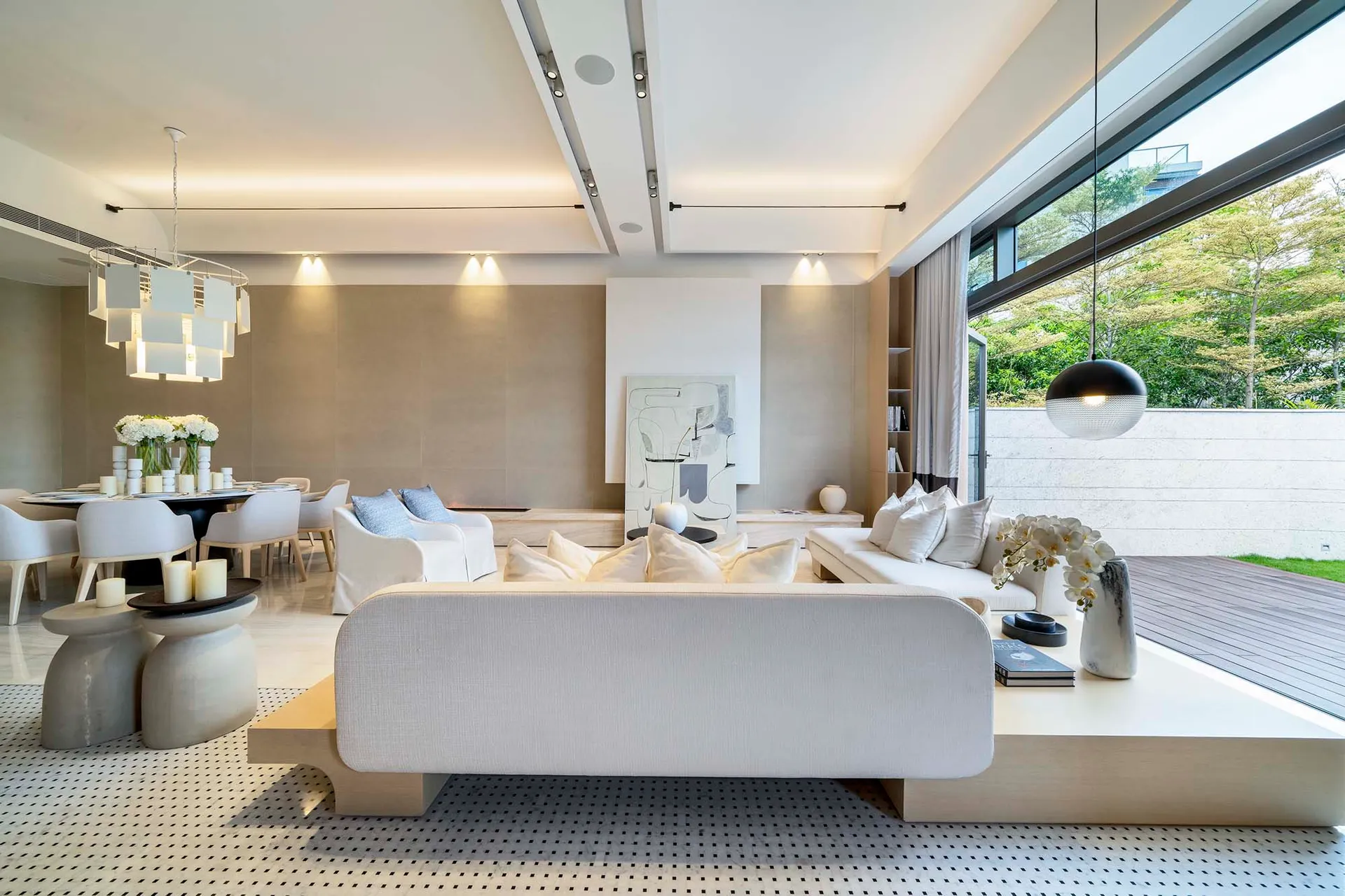 Modern minimalist living room with sleek white furniture, a unique jack-leg stool arrangement, and elegant wall art incorpora
