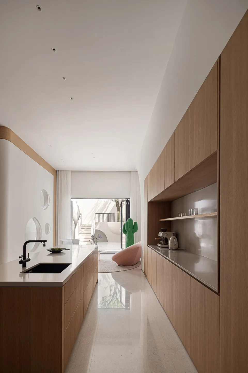 Modern kitchen featuring wooden cabinets, sleek countertops, and a black faucet.
