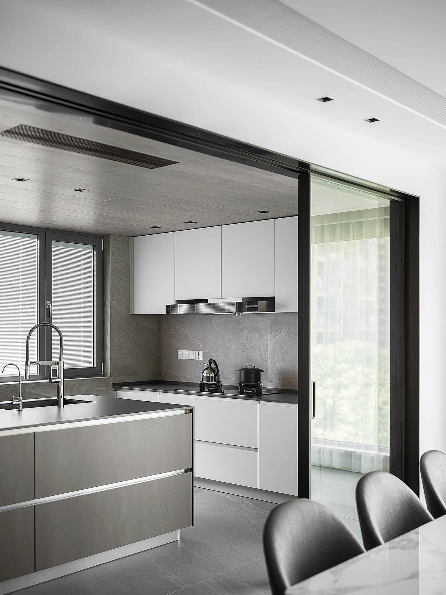 Modern minimalistic kitchen with concrete walls and white cabinetry