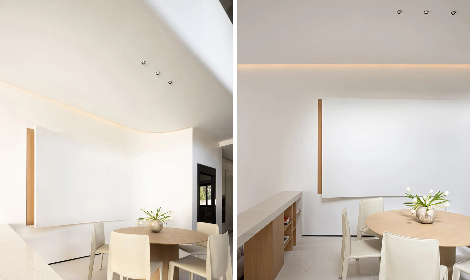 A minimalist dining area featuring white materials and a round wooden table with white chairs.