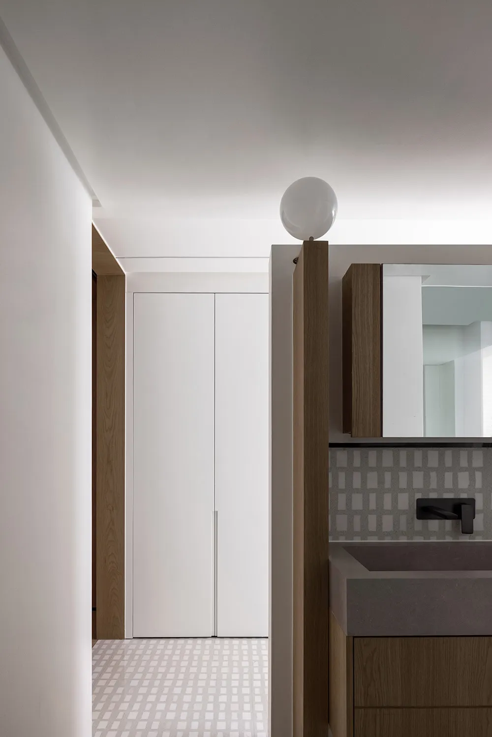 Minimalist bathroom featuring concrete countertops and wooden cabinets
