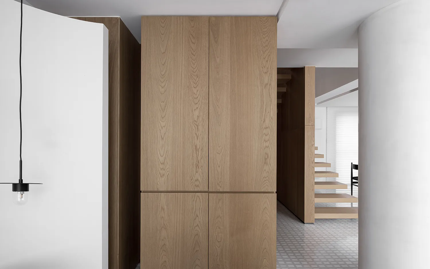 Modern minimalist hallway featuring wooden cabinets