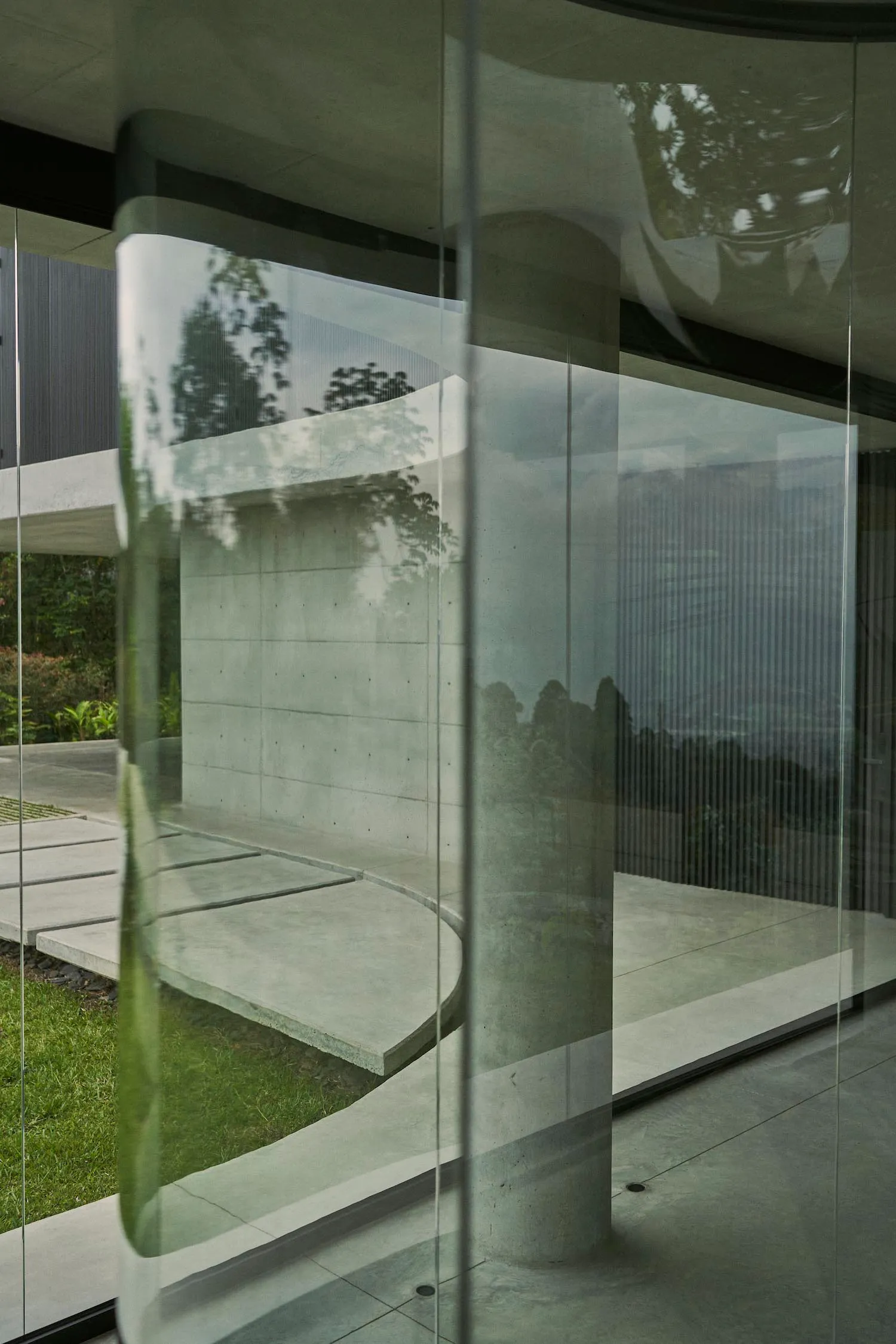 Modern exterior and interior spaces featuring concrete and glass materials