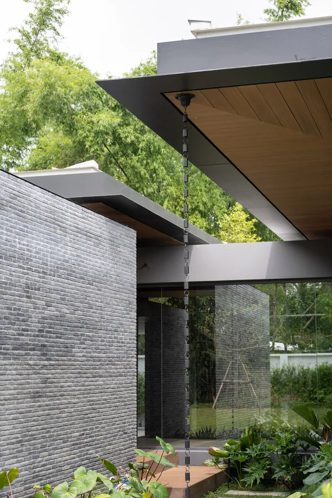 Modern exterior with concrete and brick wall, featuring a contemporary design.