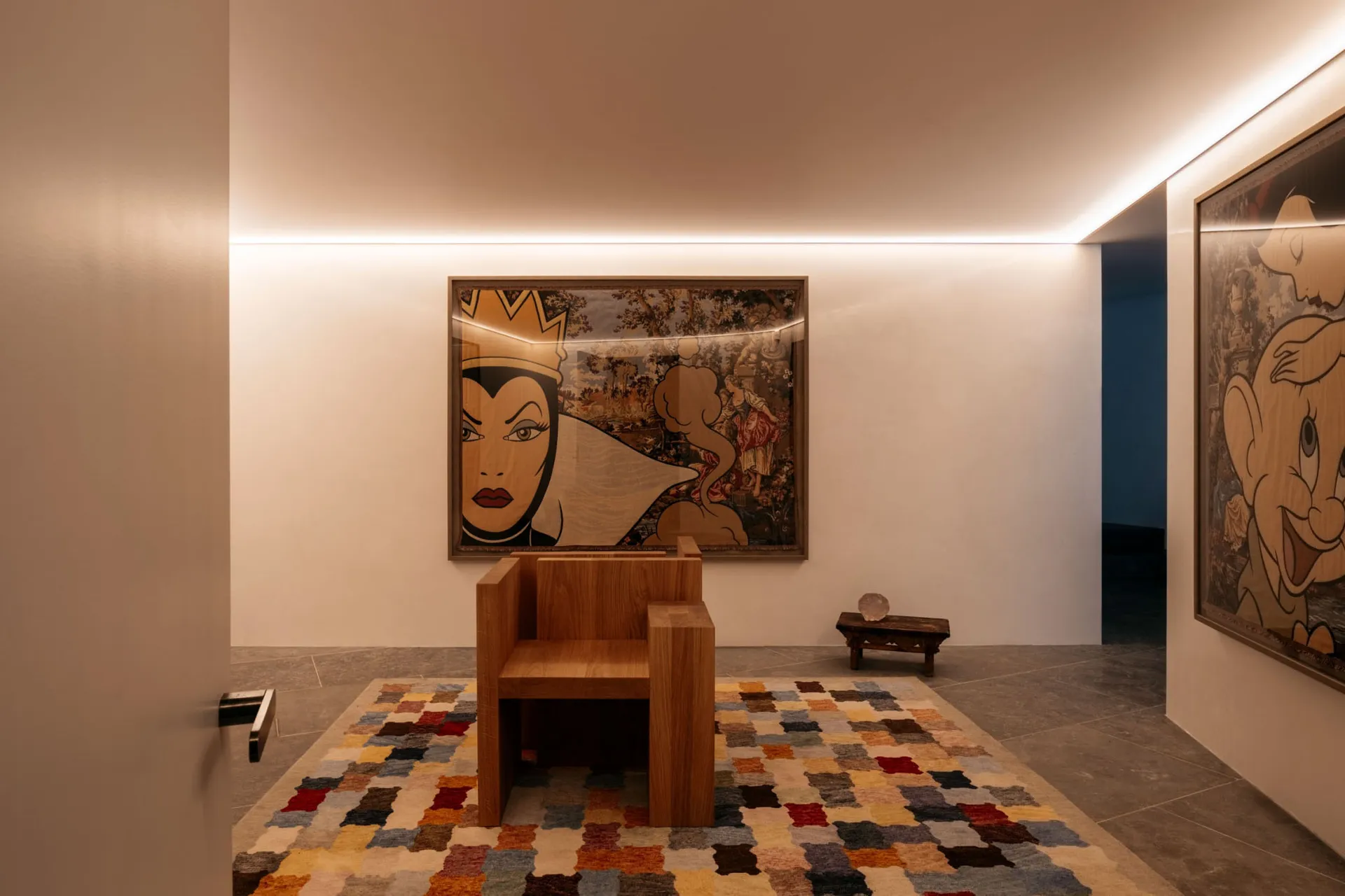 A modern lobby featuring wooden flooring, an abstract painting of a woman, and a patterned rug.
