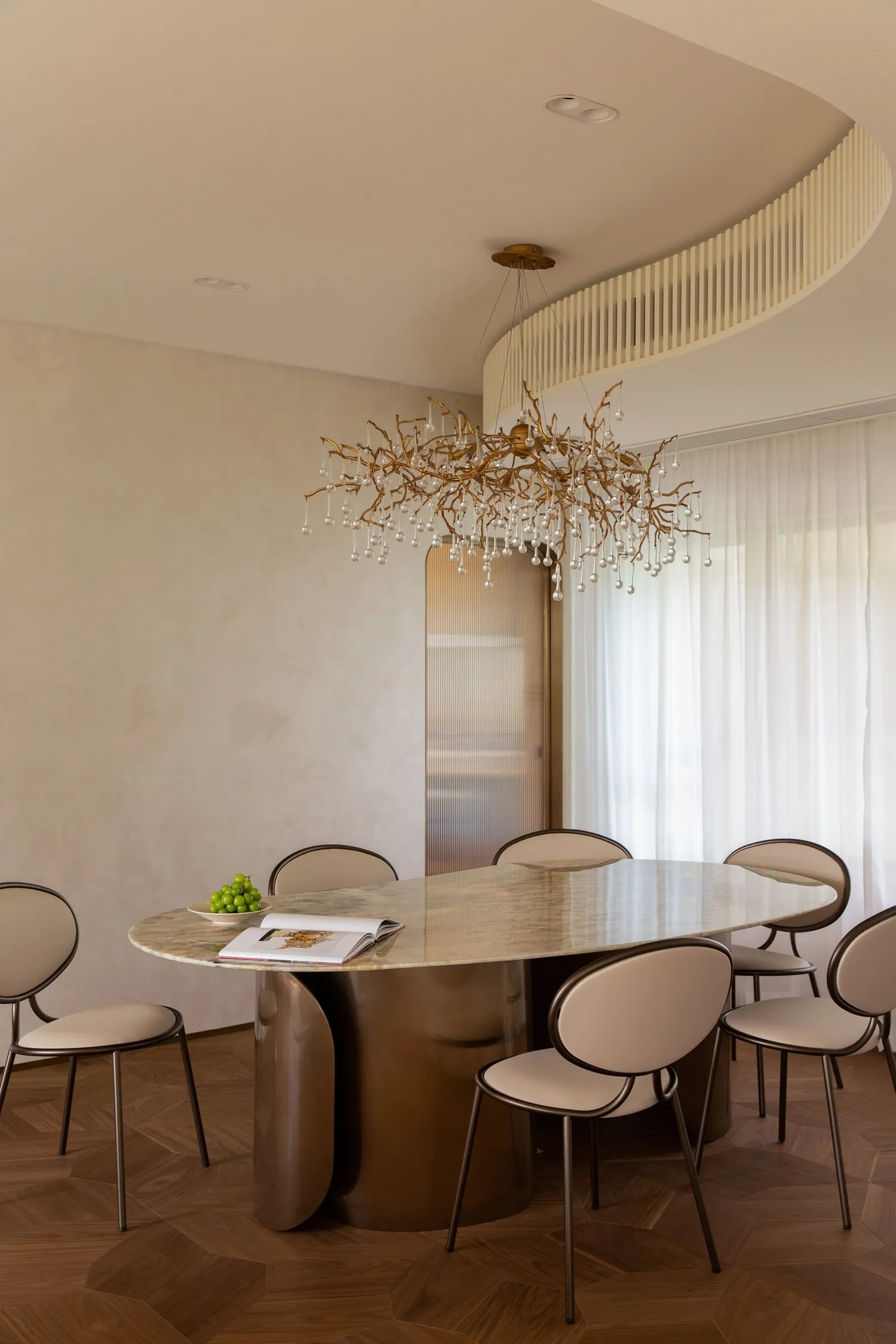Modern dining room with a marble and metal table and chairs.