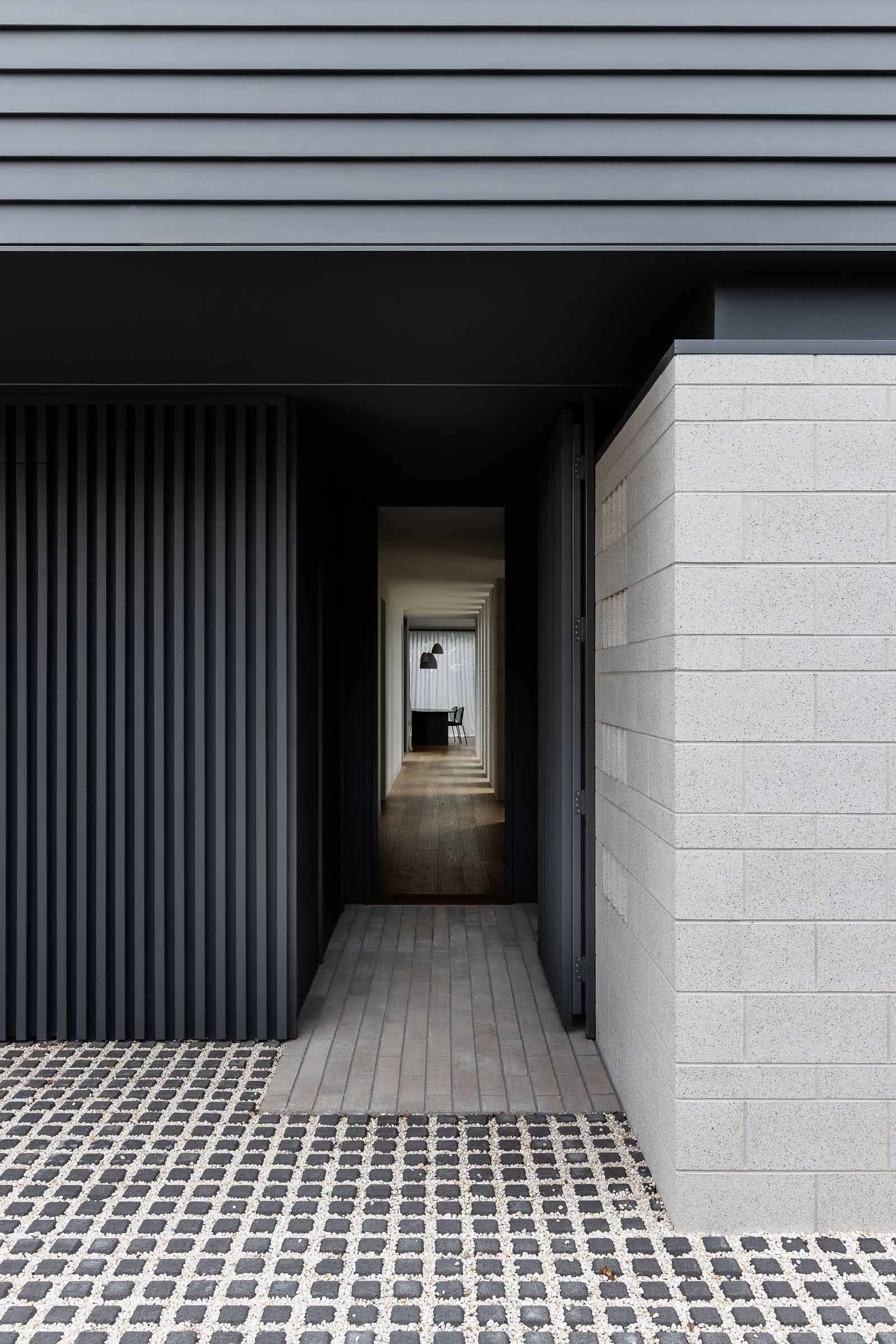 A modern exterior showcasing a concrete and stone material with a geometric design.