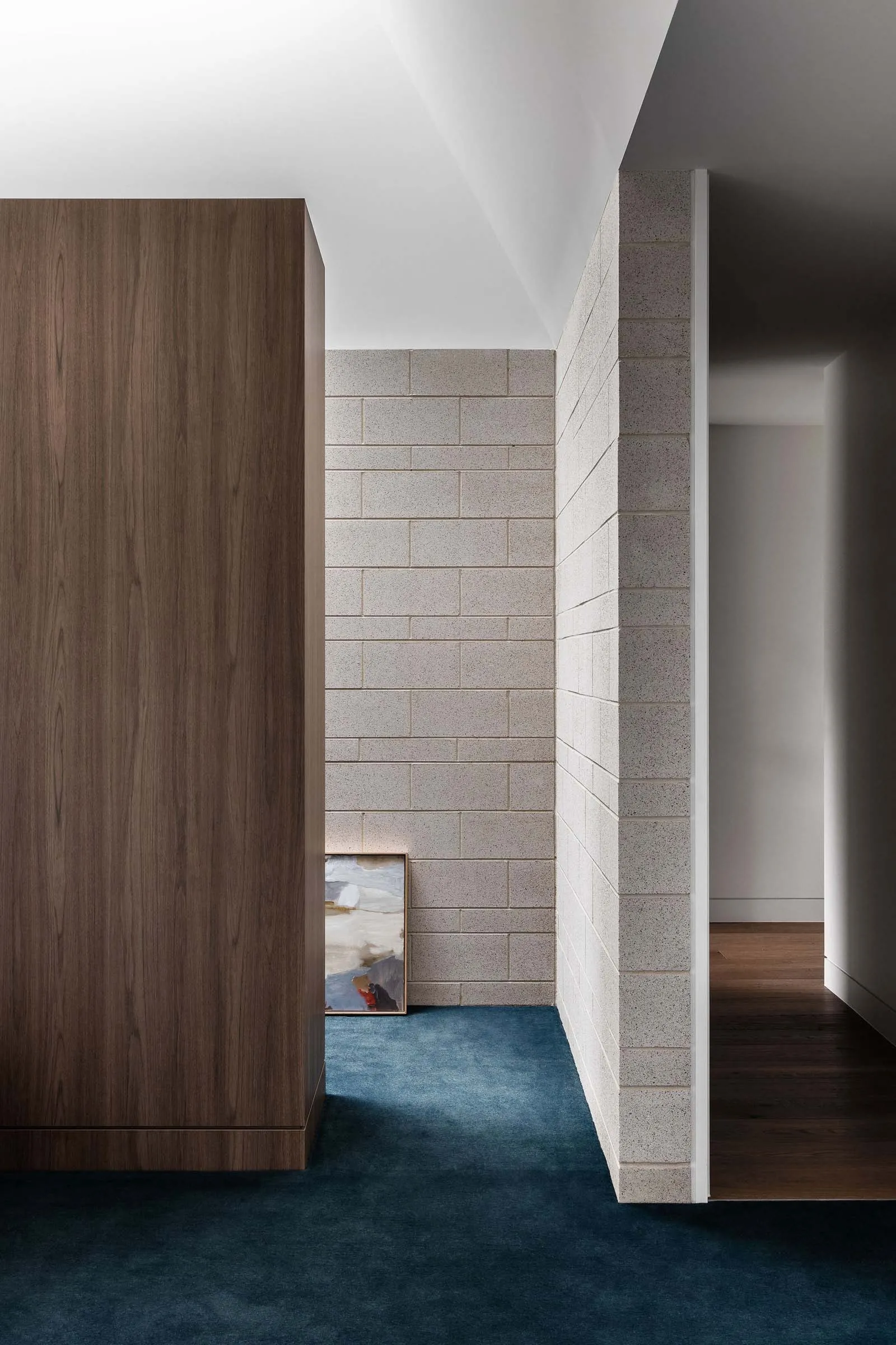 Contemporary space featuring industrial, minimalist aesthetic with concrete walls and wooden elements