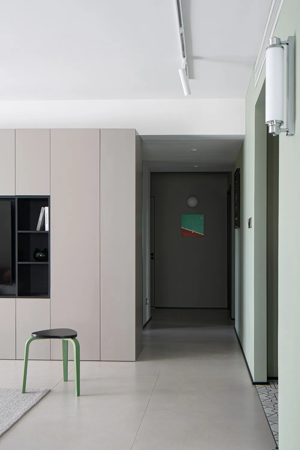 Modern residential hallway with minimalist design and painted cement subfloor.