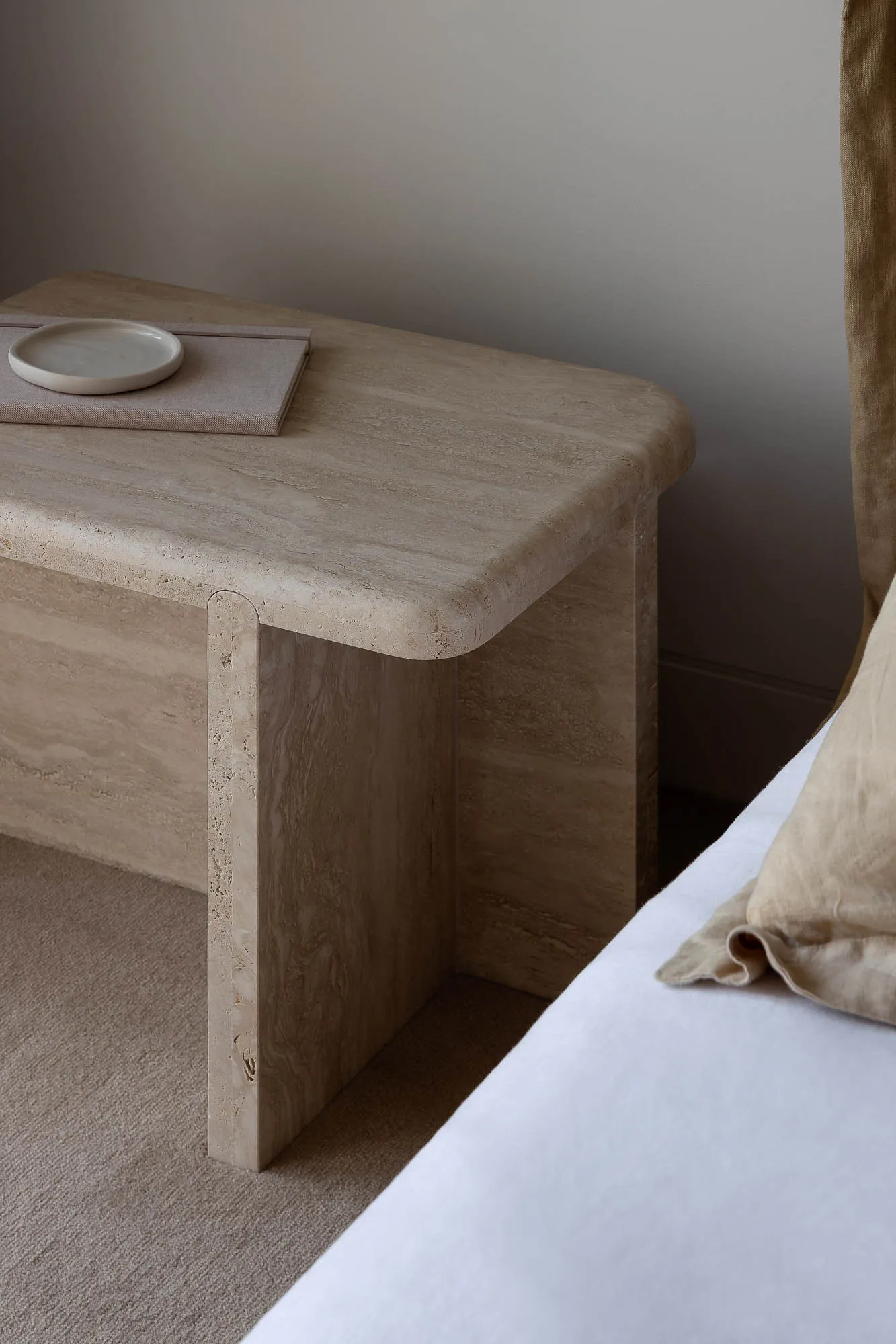 A modern, minimalist marble bedside table with a simple, clean design.
