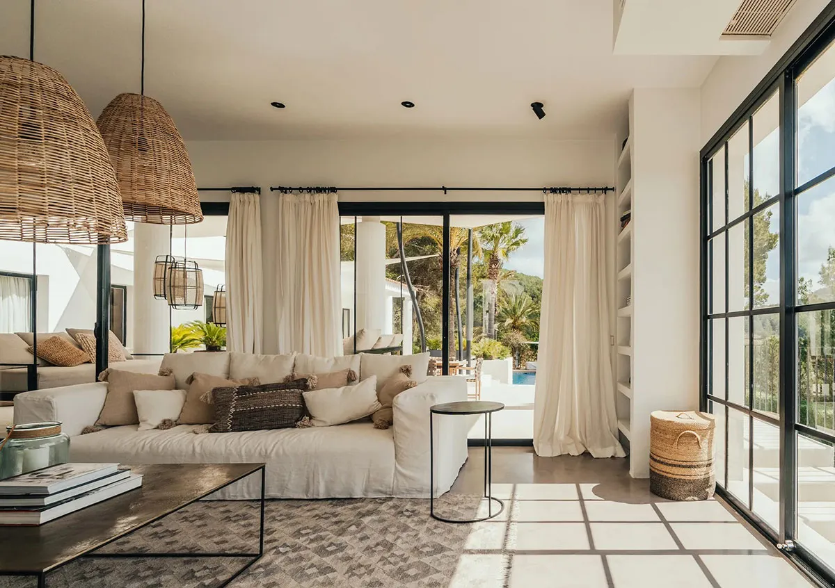A minimalist living room with neutral tones and leather accents.