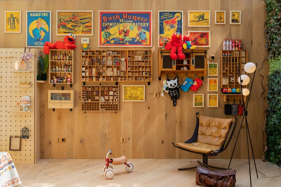 A wooden interior displaying various toys and vintage posters.