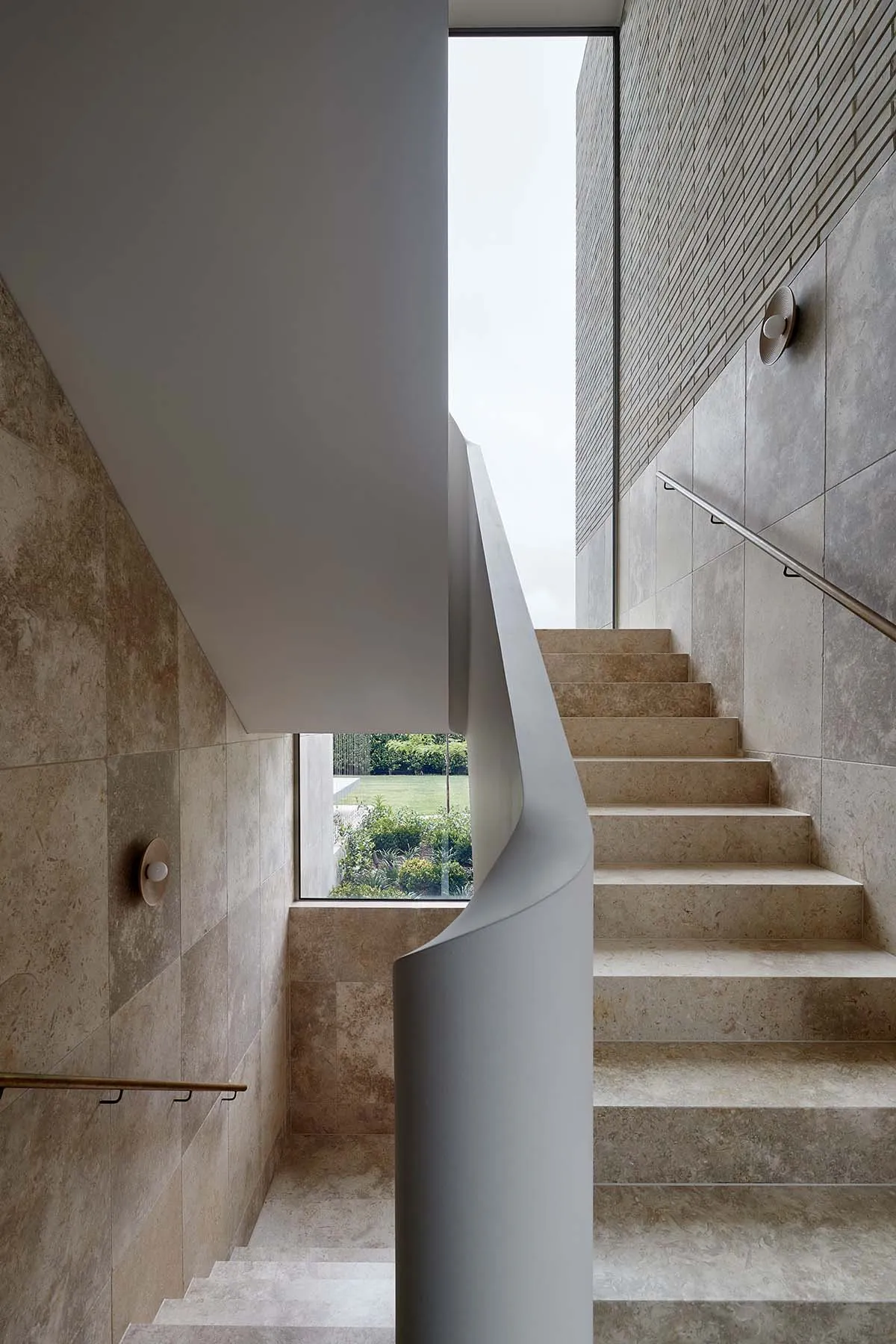 Modern minimalist staircase with marble steps and glass railings
