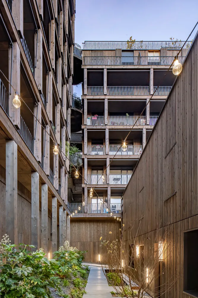 Modern residential architecture featuring wood exterior and balconies.