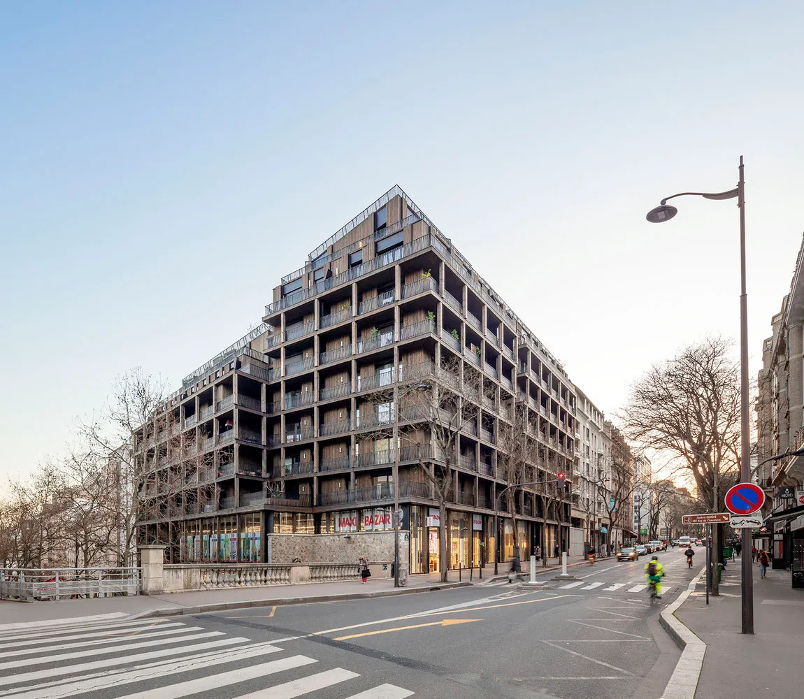 A modern building with a concrete facade and balconies.