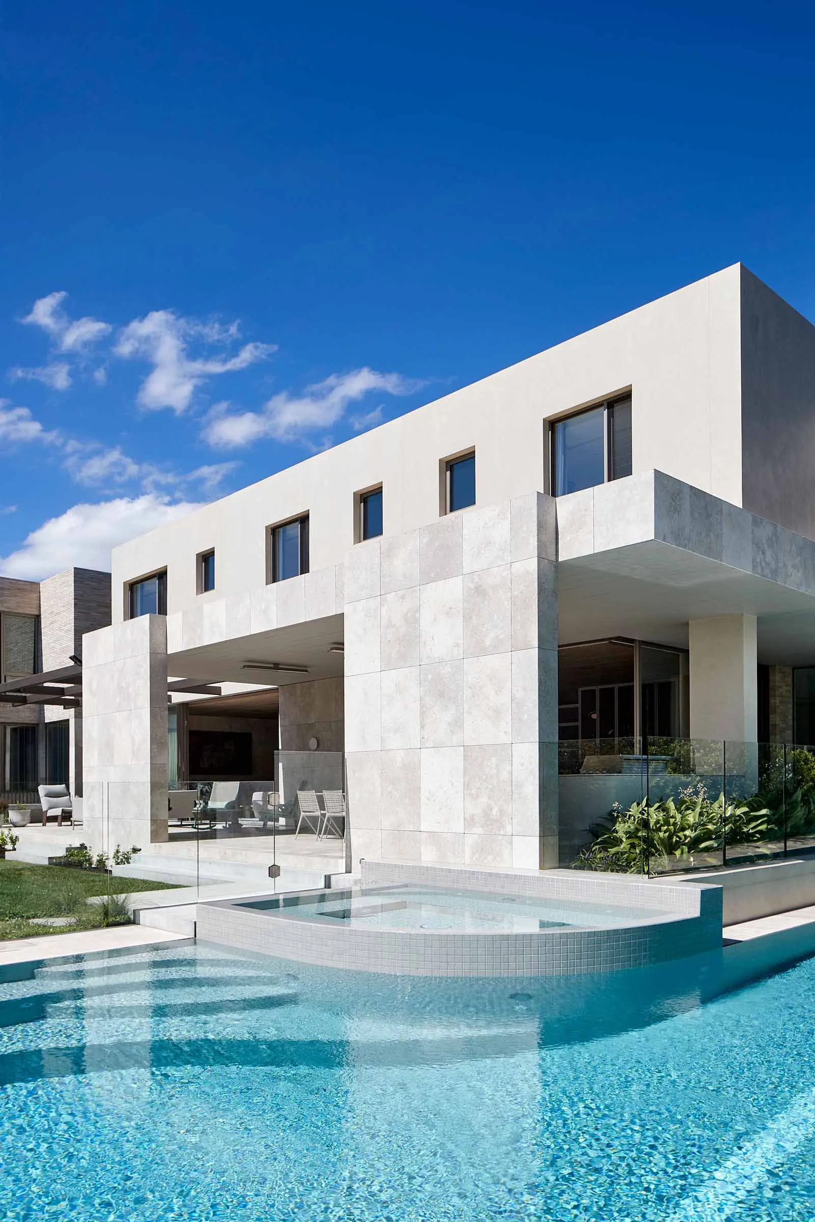 Modern residential home with concrete and glass exterior features.