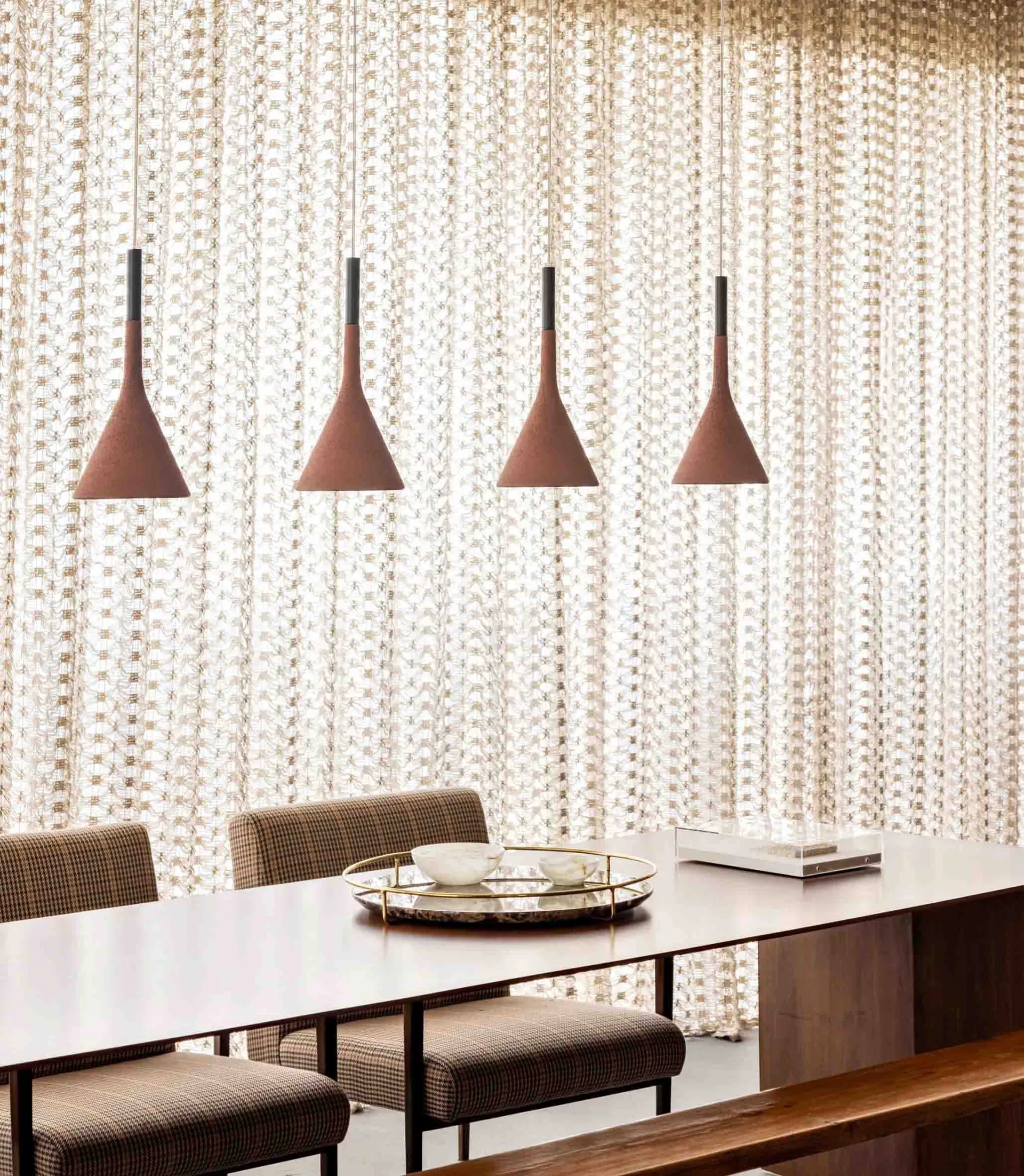 Modern dining room with wooden pendant lights and textured wall