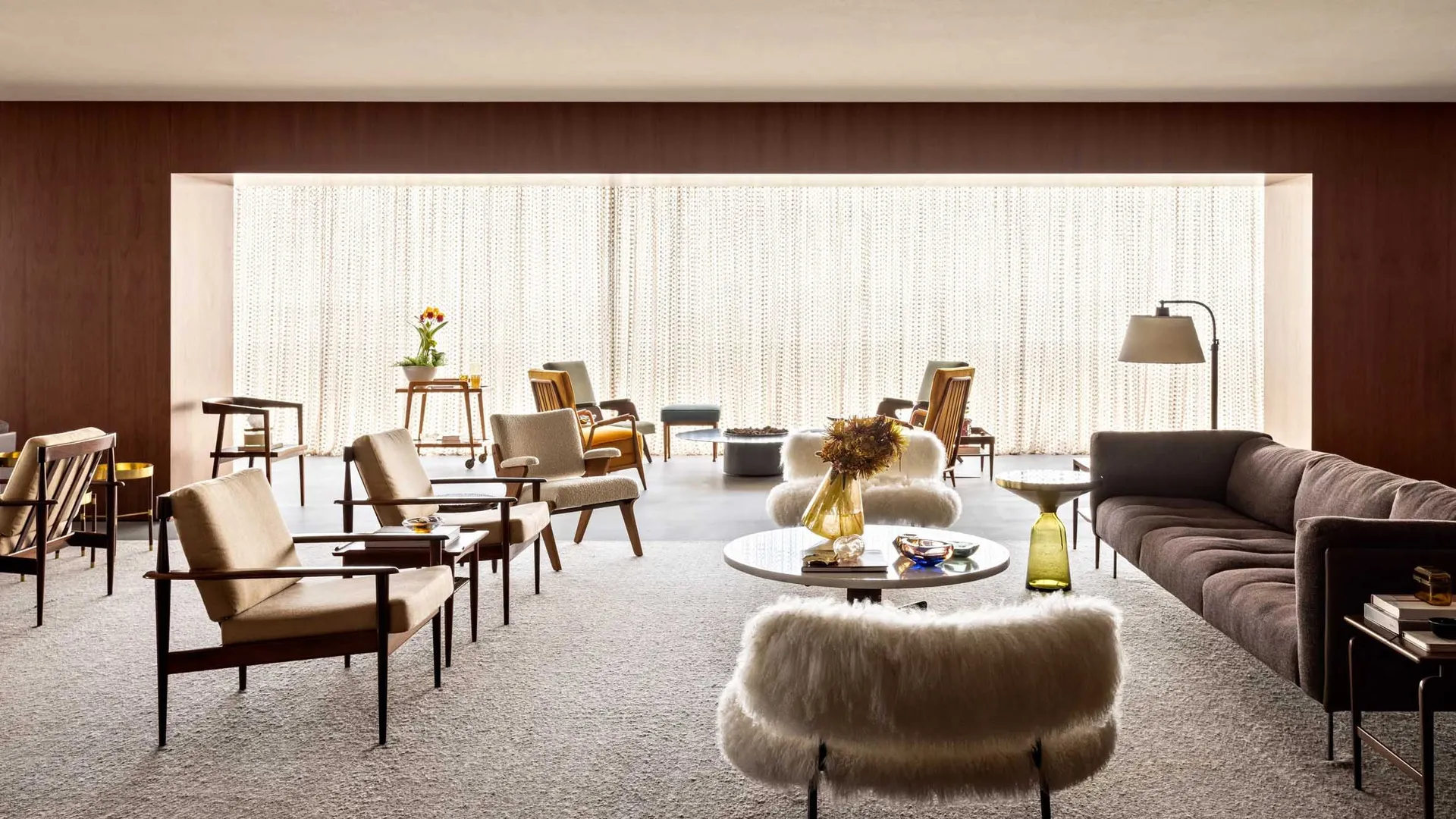Modern living room with upholstered couch, chairs, and coffee table.