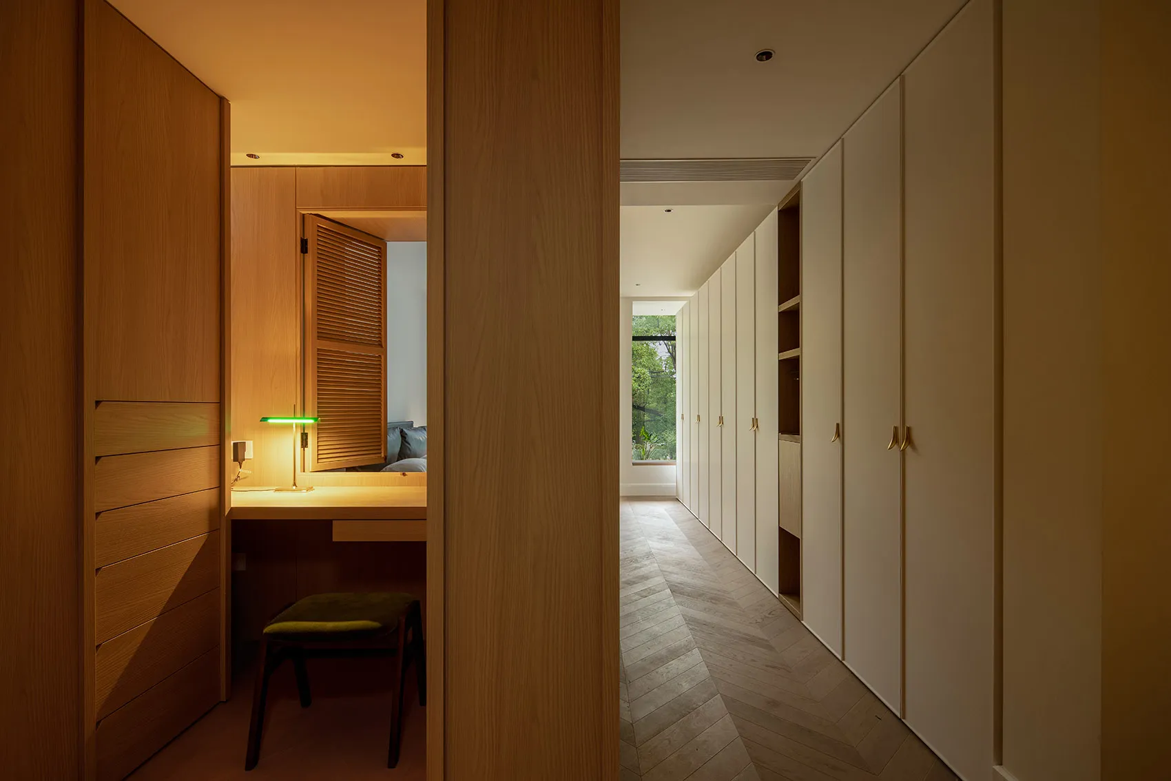 Modern house interior with minimalist design featuring white cabinets and wooden finishes.
