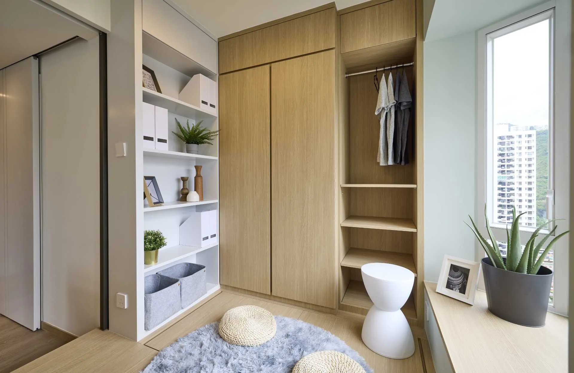 Modern interior space featuring a wooden closet with open shelves and storage bins.