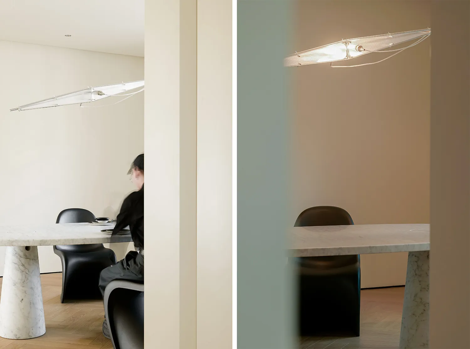 A minimalist dining room featuring a marble table and black chairs under a contemporary light fixture.