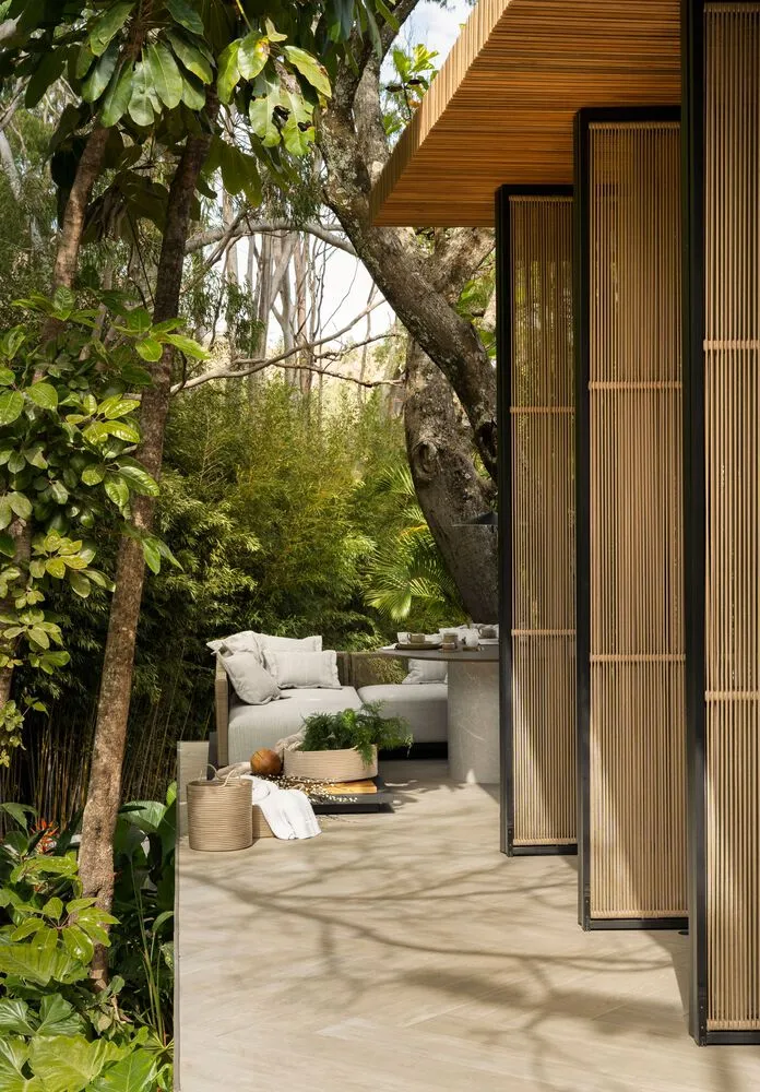 Modern, indoor lounge area with wooden materials and greenery.