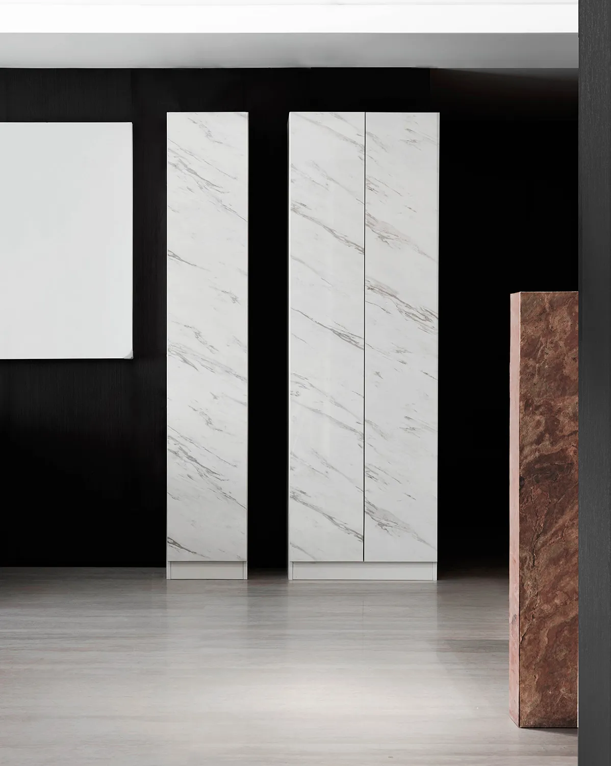 A minimalist storage unit with marble doors in a modern interior setting