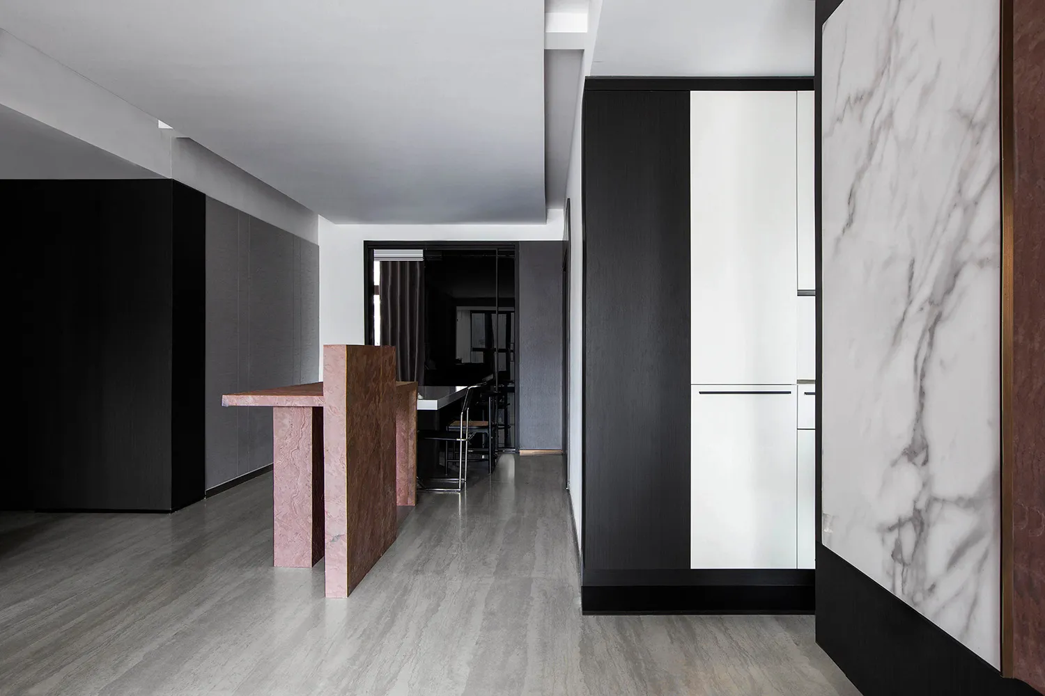 A minimalist interior space featuring marble and wood elements.
