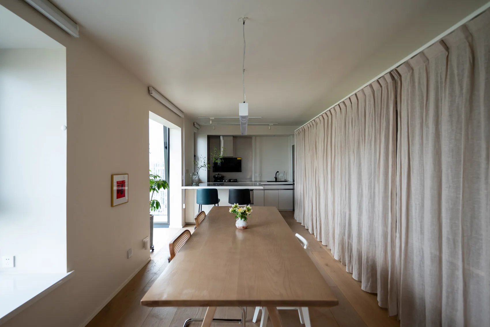 Modern dining room featuring a wooden table and minimalist decor.