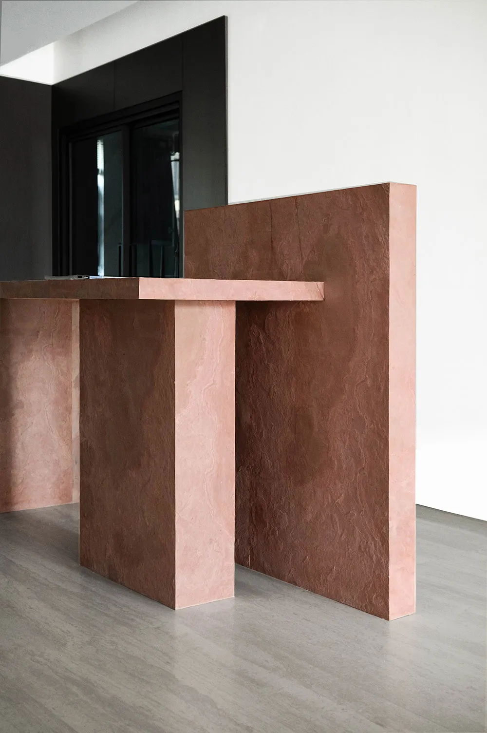 A modern reception desk made of concrete.