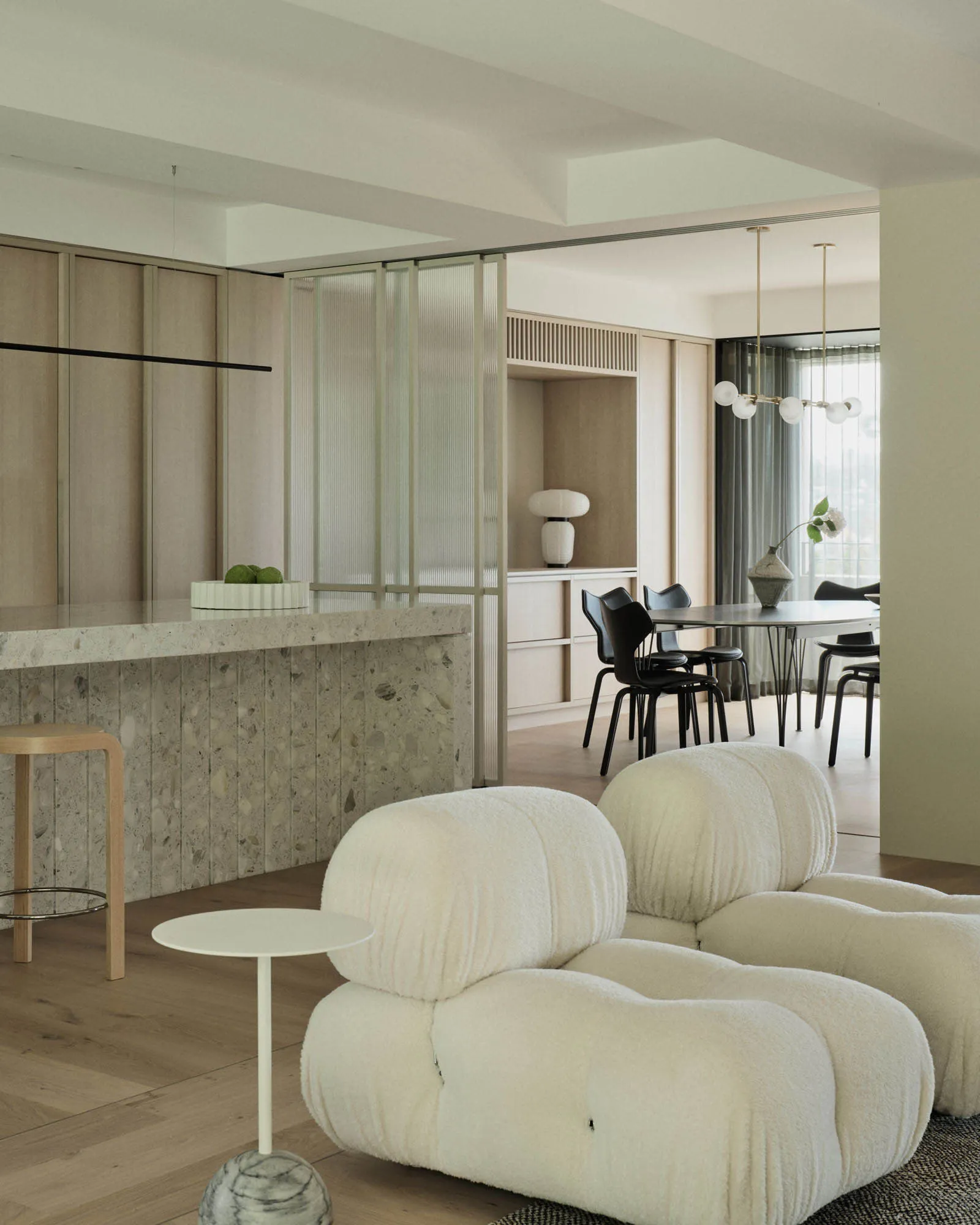 Modern interior design featuring a marble countertop and cozy, wool-textured sofa in minimalist living room setting