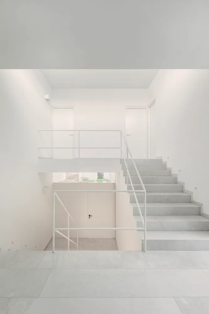 Modern concrete staircase in a minimalist white interior