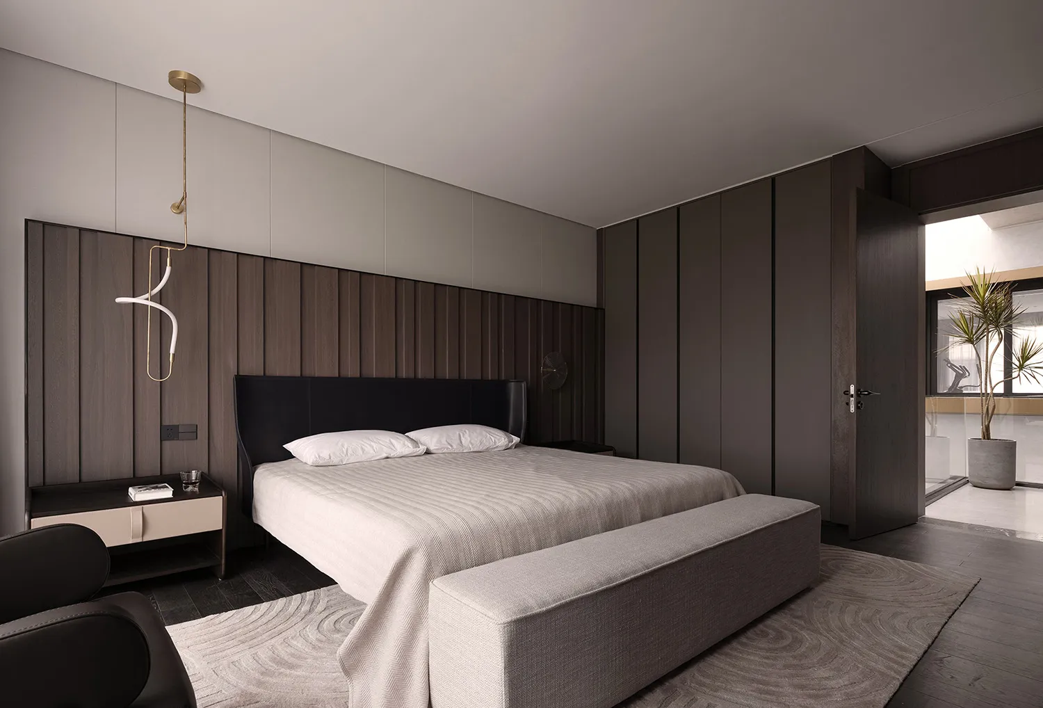 Modern minimalist bedroom with a cozy bench, minimalist design details, and a light wood headboard.